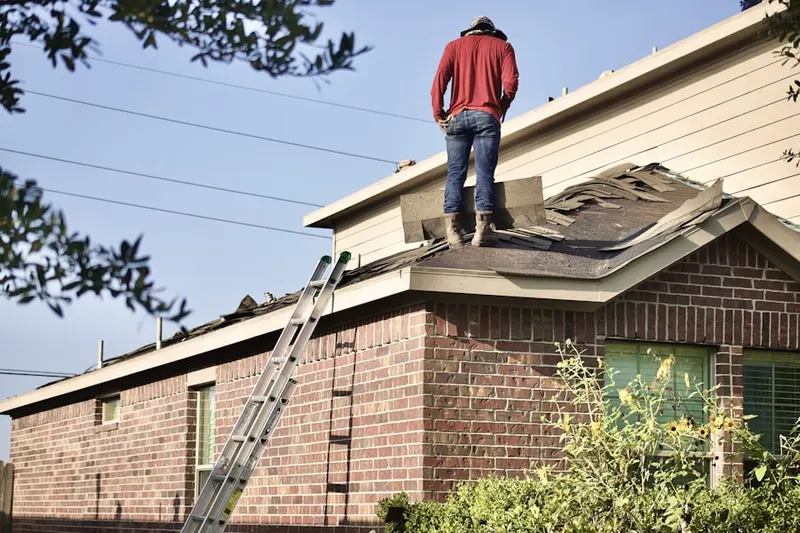 Professional roofer working on a residential roof in D Street - West Broadway